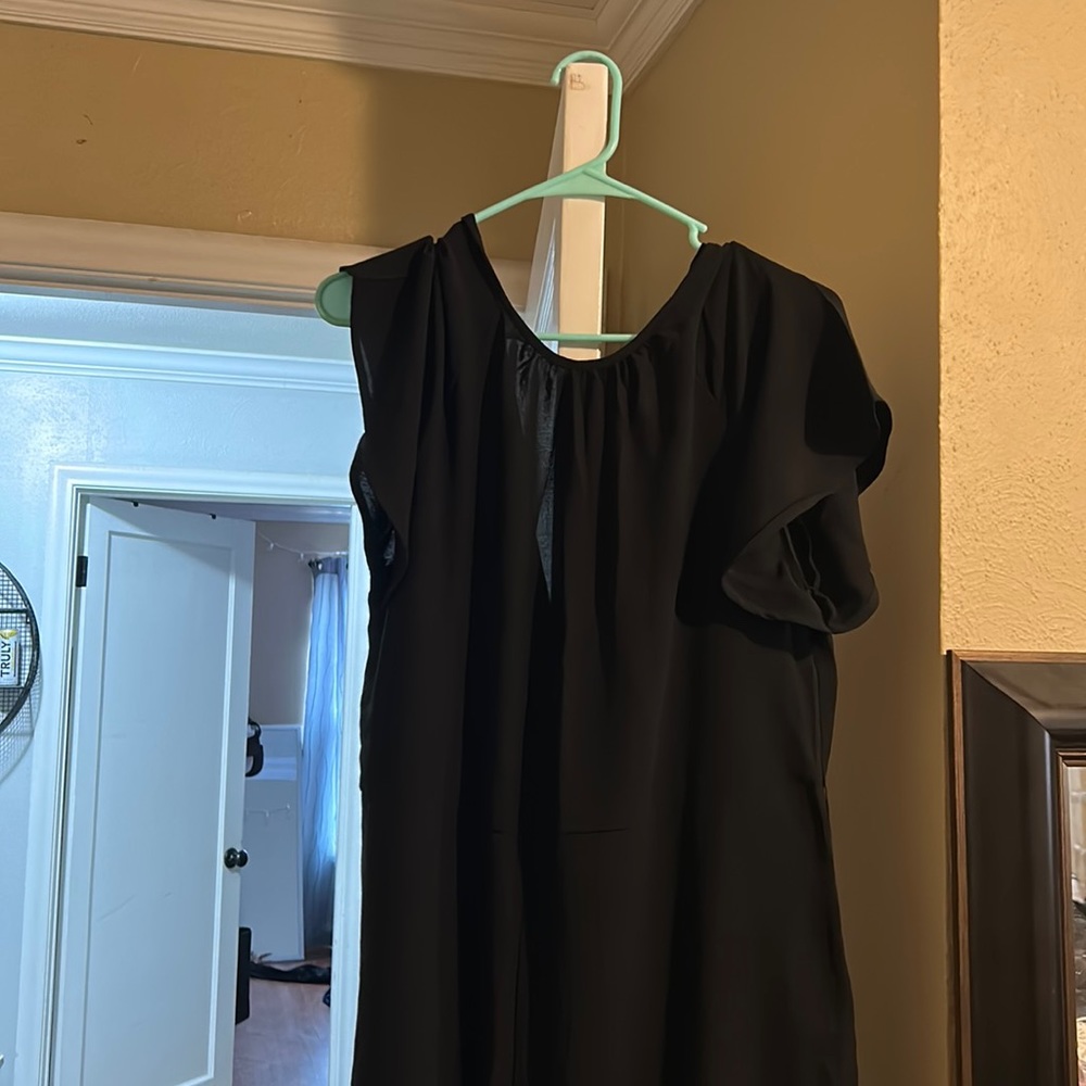 Black jumpsuit. Never worn. Short sleeves. Higher neck.